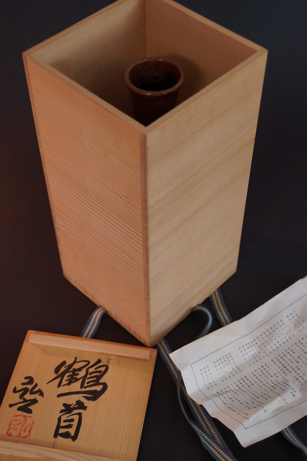 The Vase Standing in the Opened Storage Box Next to Box Lid, Cord, and Certificate of Authenticity
