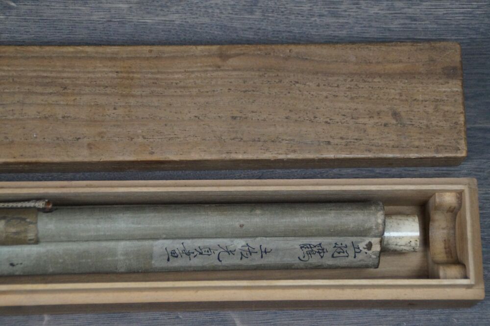 Opened storage box with rolled-up hanging scroll Cranes in Flight over Bamboo