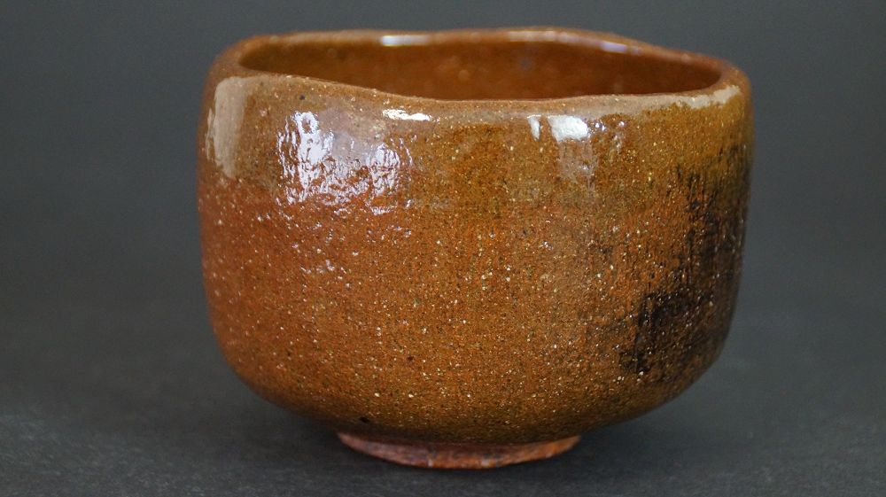 Another view of the chawan made of Ohi ware with dark glaze streaks at the rim