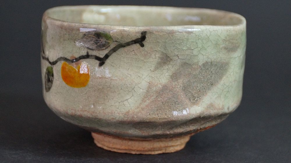 Further view of the chawan made of Kyoto ware with complete persimmon branch motif