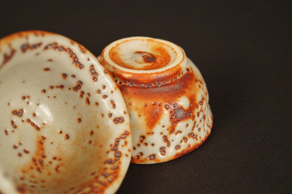 Sake cup turned upside down with foot ring guinomi base close-up