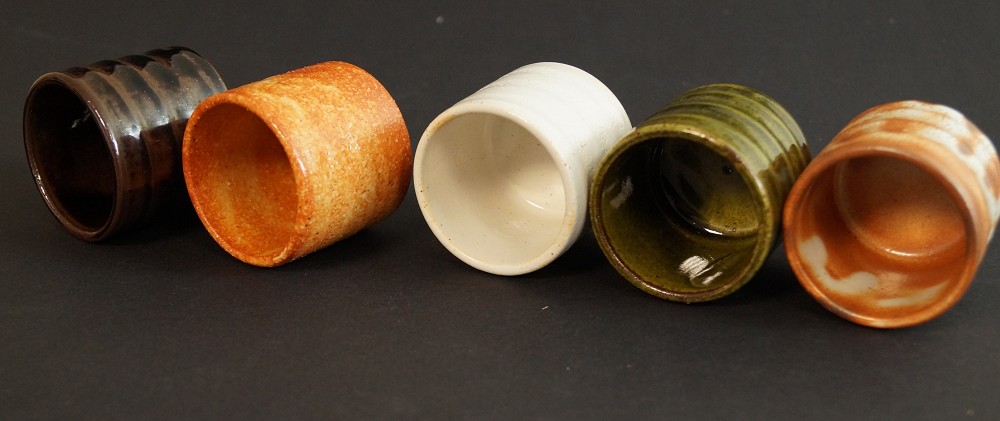 Five sake cups slightly tilted with view into the openings, set side view 2