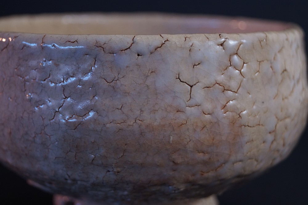 Extreme close-up of the crackled Hagi glaze with fine speckles