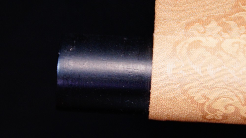 Close-up of the black lacquered scroll end of the hanging scroll