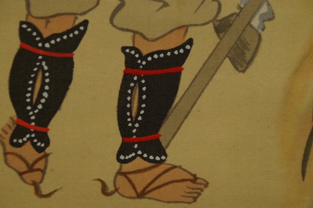 Close-up of the retainer's black leg armor with lance shaft