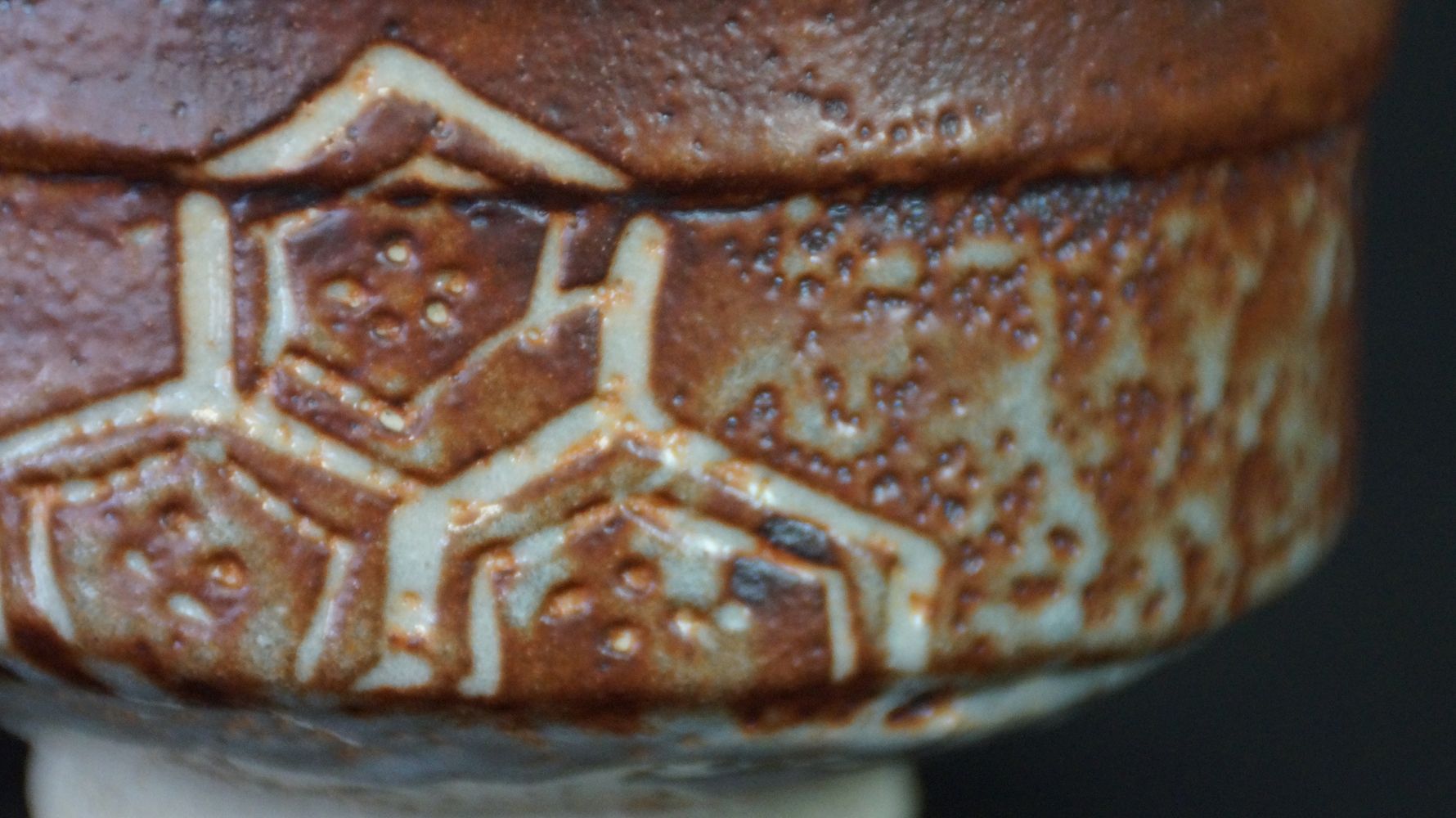 Extreme close-up of the incised hexagon pattern of the chawan tea bowl made of Shino ware
