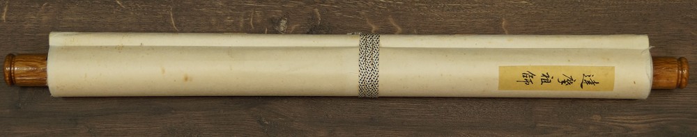 Rolled-up kakemono with title label and cord, plus wooden jikusaki