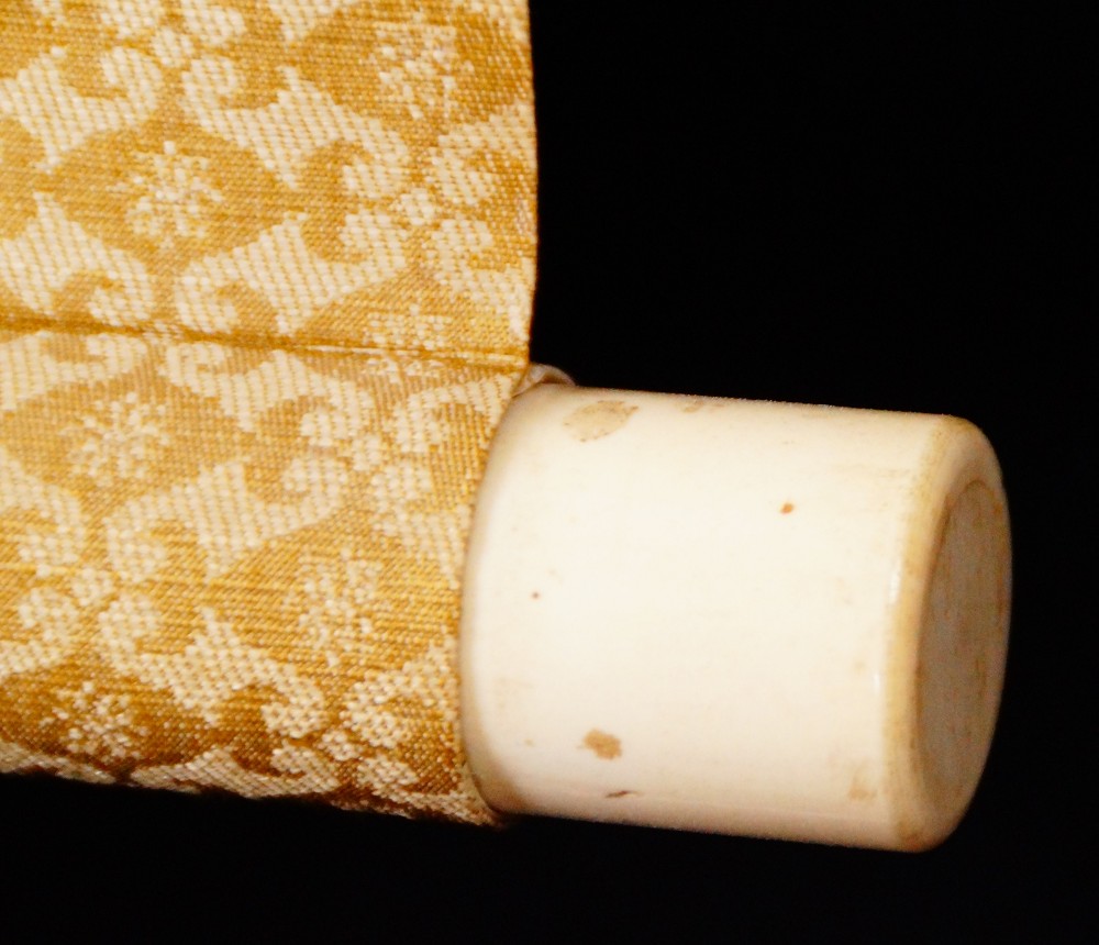 Close-up of the ivory-colored roller end of the kakemono