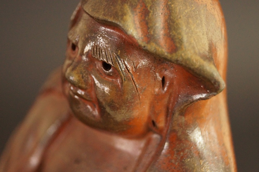 Bodhidharma Daruma figure made of Bizen ware motif close-up 2 face