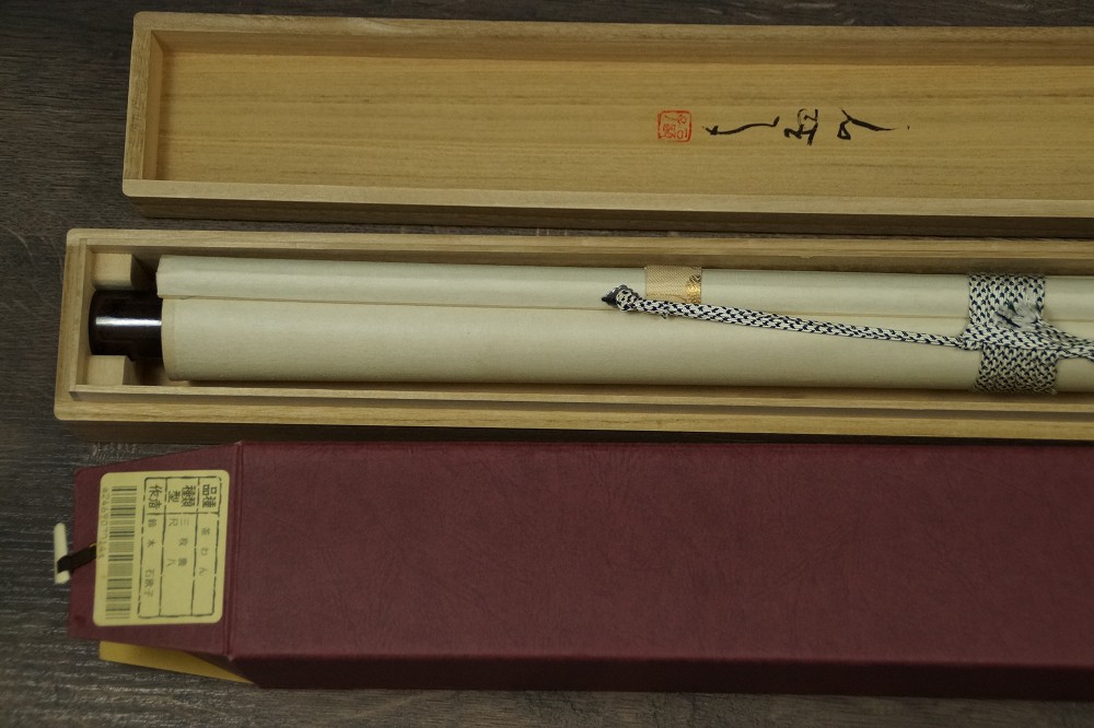 Rolled-up kakemono in the storage box with ceramic jikusaki
