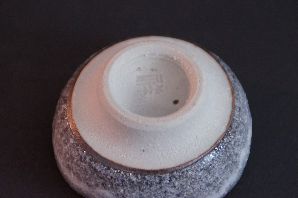 Close-up of the white-glazed foot with stamped potter's mark