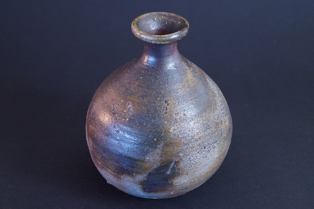 Another side view of the tokkuri with earthy brown tones and blue-gray ash effect