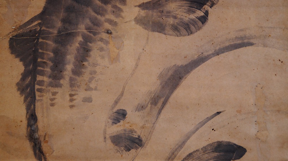 Close-up of the expressive ink brushwork on fin and water waves