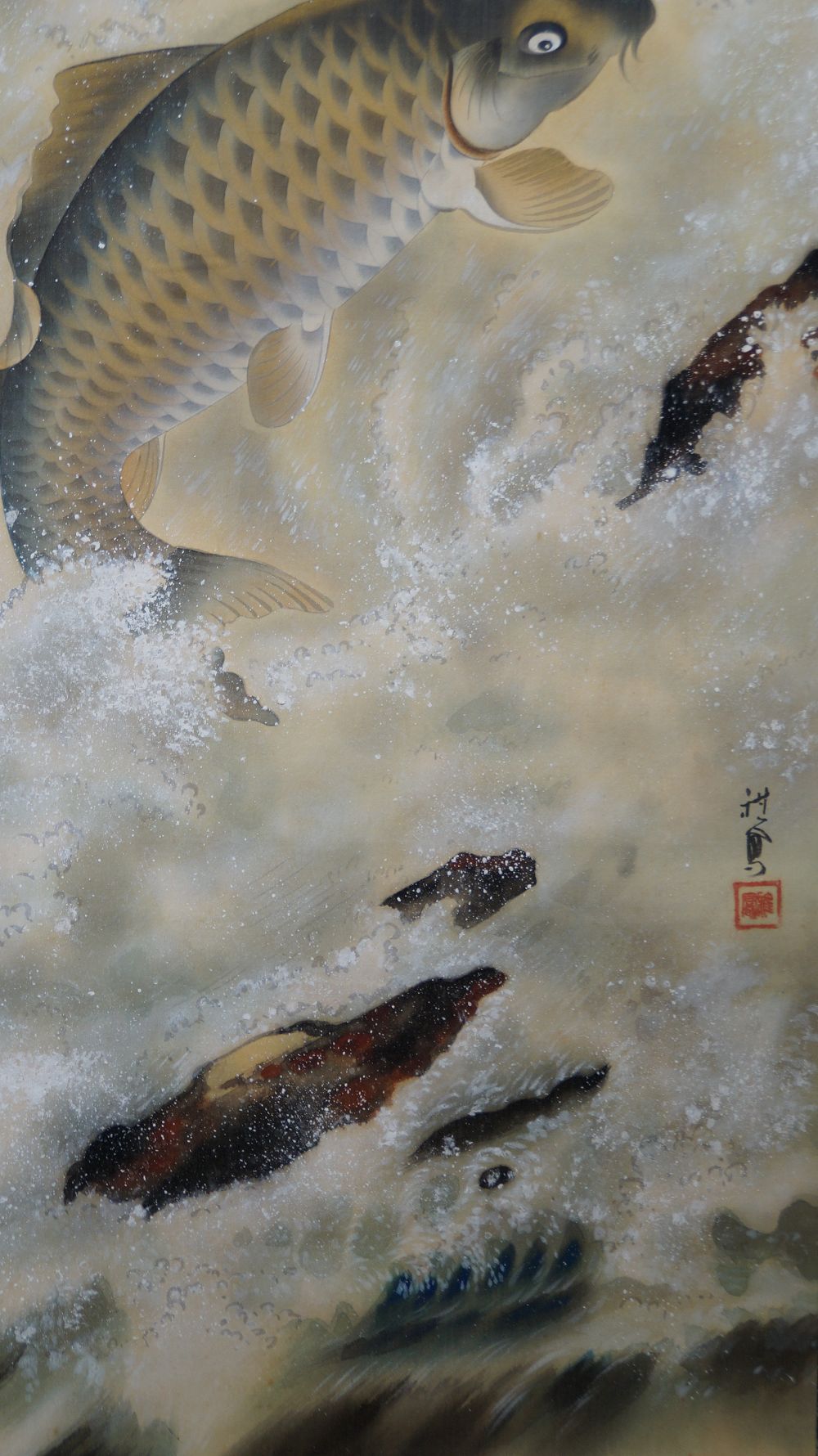 Close-up of the leaping carp with artist's signature and red seal in the hanging scroll carp in a turbulent waterfall