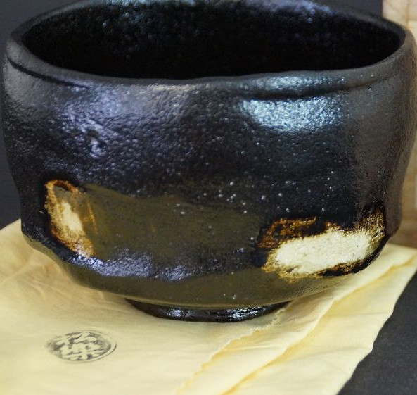 Chawan made of Raku ware by Shoraku Sasaki with black glaze and gold-colored glaze spots