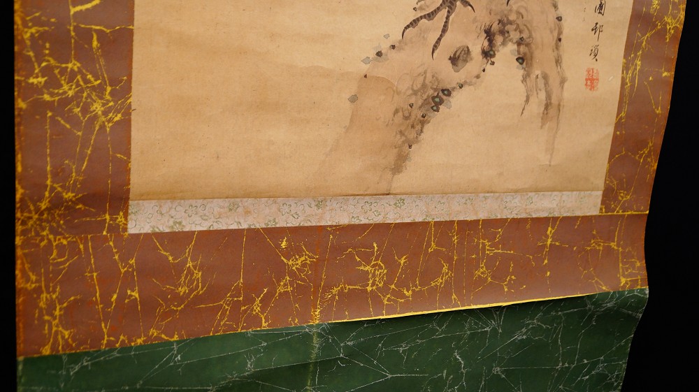 Detail of the lower mounting of the kakemono with pale blossom damask and green frame fabric