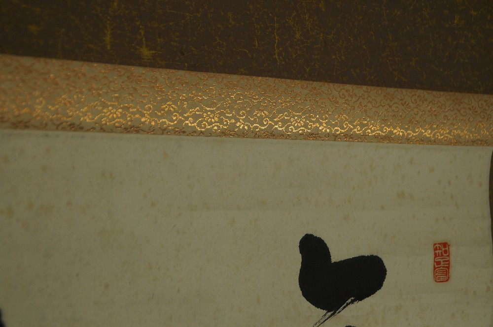 Detail shot of the mounting with brown-and-gold brocade band