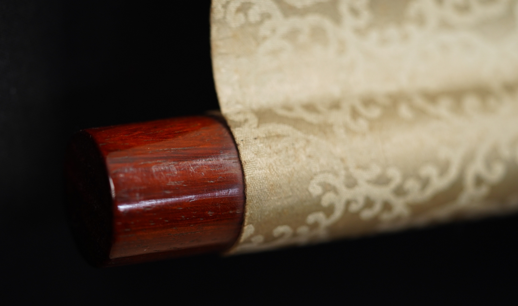 Further detail view of the scroll end with lacquer knob and silk mounting of the Kakemono Songbird on Blooming Plum Tree