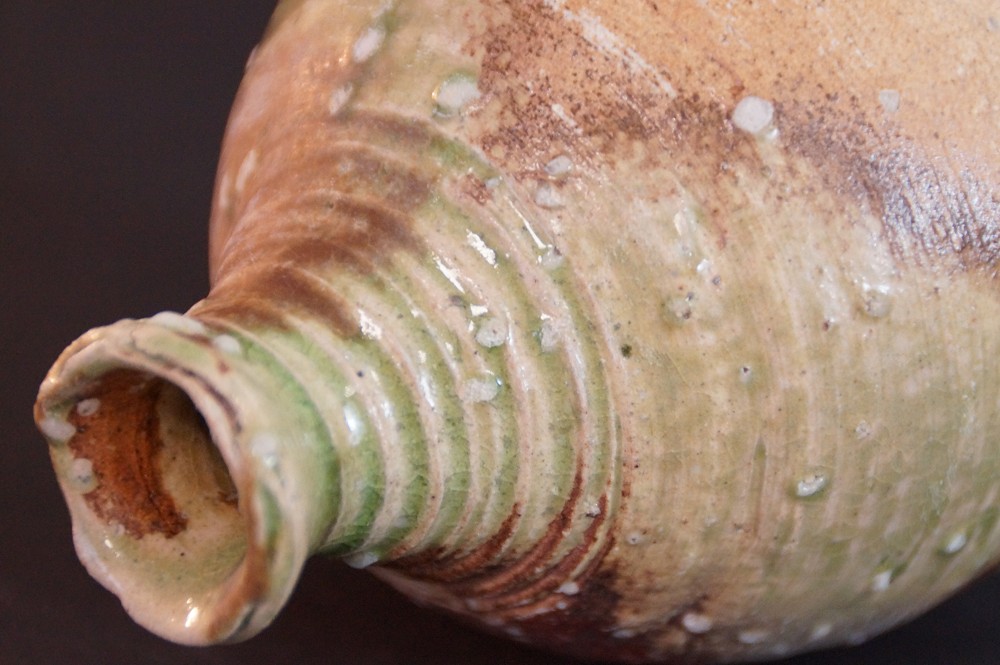 Close-up of the slender neck with ridged texture and green glaze