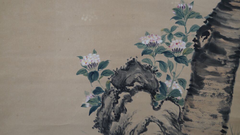 Close-up of the pink blossoms on the rock next to the tree trunk in the hanging scroll Spring Duet on a Blossoming Branch