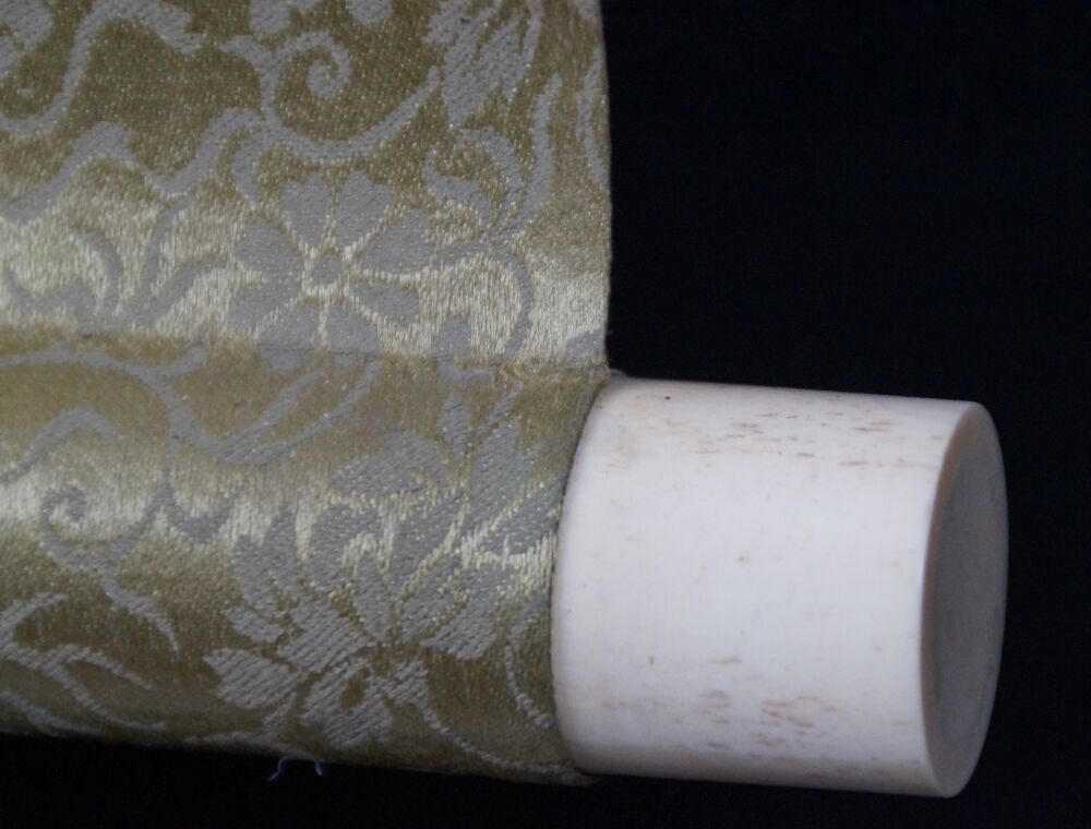 Detail view of the roller end with ivory knob and gold brocade silk of the Hanging Scroll Autumn Chrysanthemums