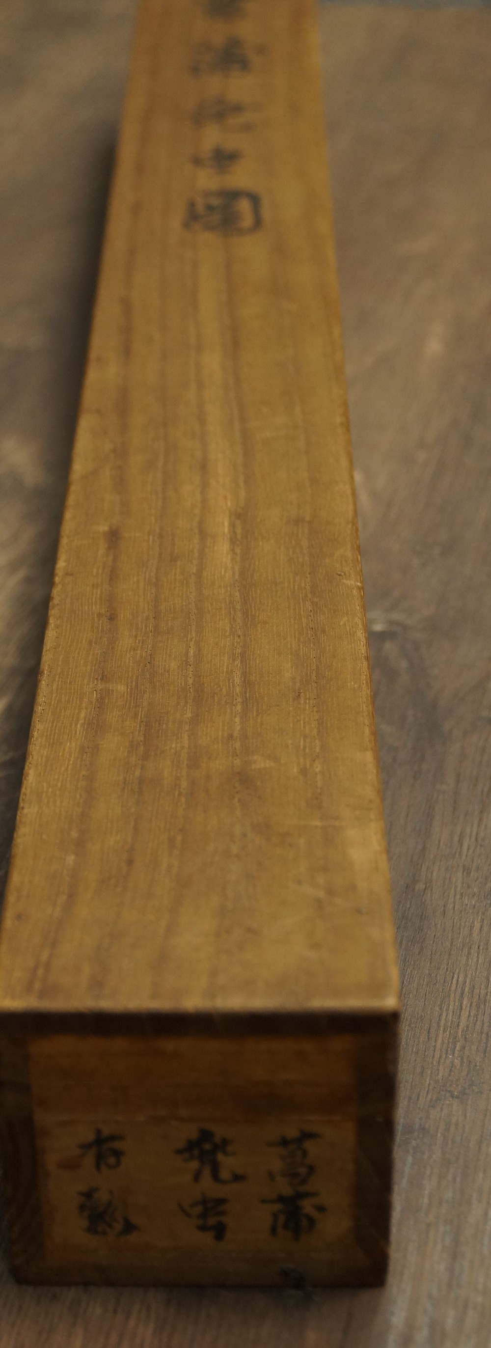 Close-up of the wooden storage box with ink inscription