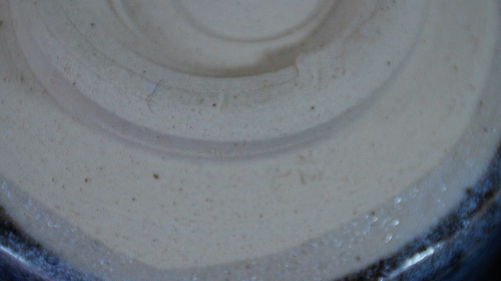 Extreme close-up of the unglazed chawan foot by Kazufumi Wada with visible throwing marks