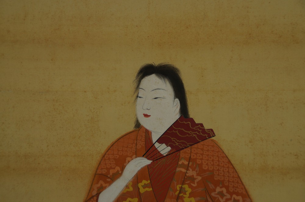 Close-up of the woman's face with red fan