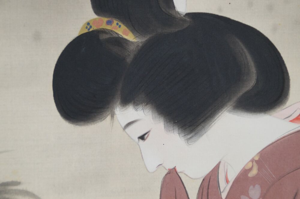 Close-up of the elaborate hairstyle of the lady in profile in the hanging scroll Lady in Kimono by the Garden Pond