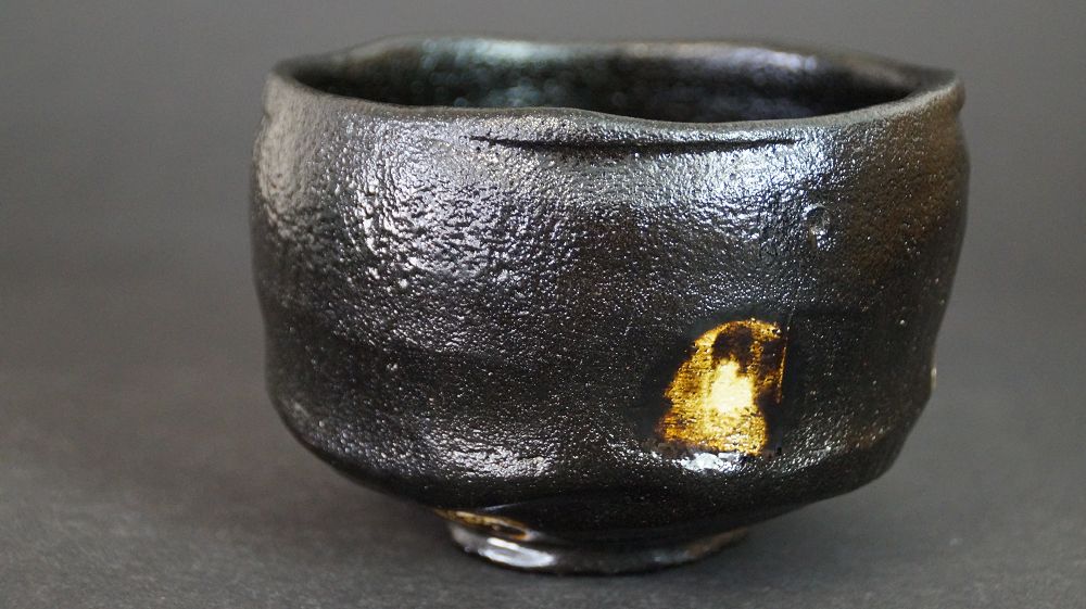 Additional view of the chawan made of Raku ware with single gold-colored glaze spot