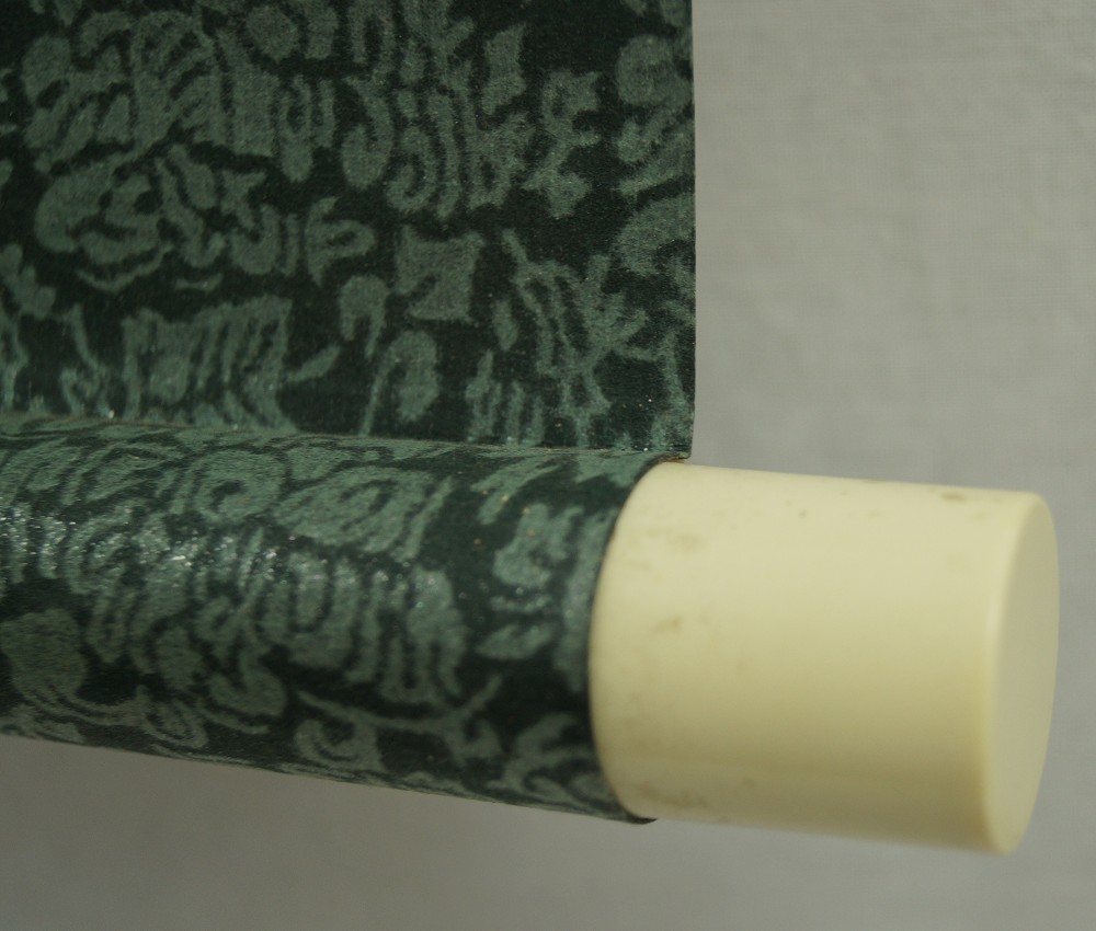 Landscape with waterfall and raftsmen close-up of the scroll end jikusaki scroll detail