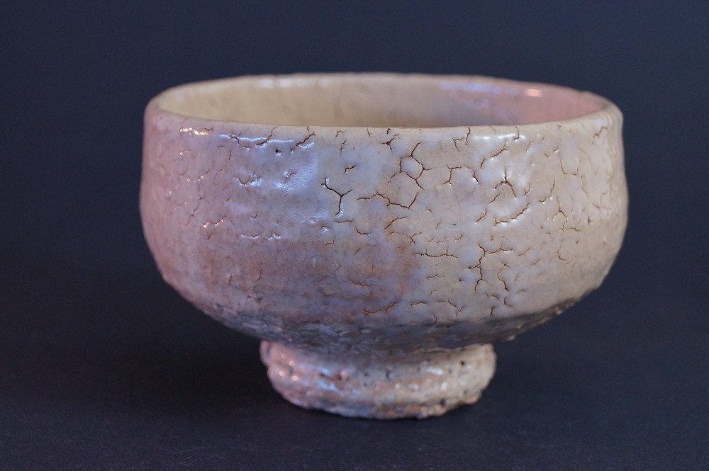 Additional side view of the chawan with pink to cream-colored glaze