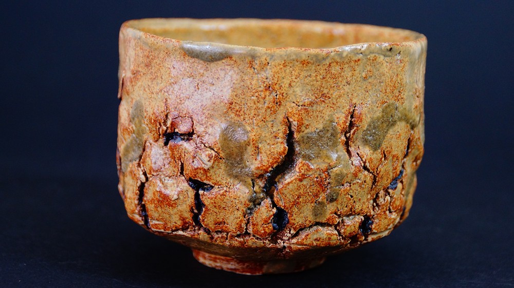 Further side view of the chawan made of Seto ware by Takamichi Kato with irregular, crackled walls