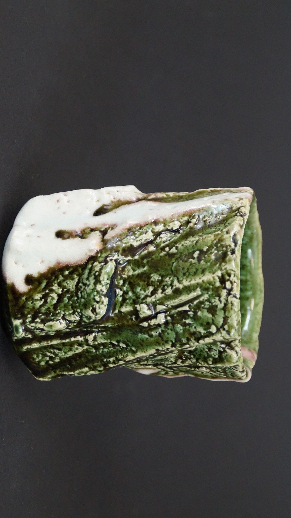 Further view of the yunomi tea bowl made of Oribe ware with green and white glaze section
