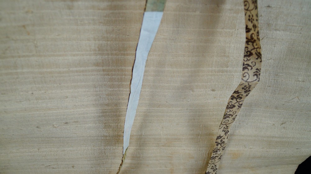 Close-up of the textile hanging cord and the patterned border band
