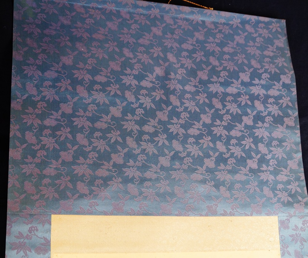 Detail of the mounting of the kakemono with blue-violet blossom brocade