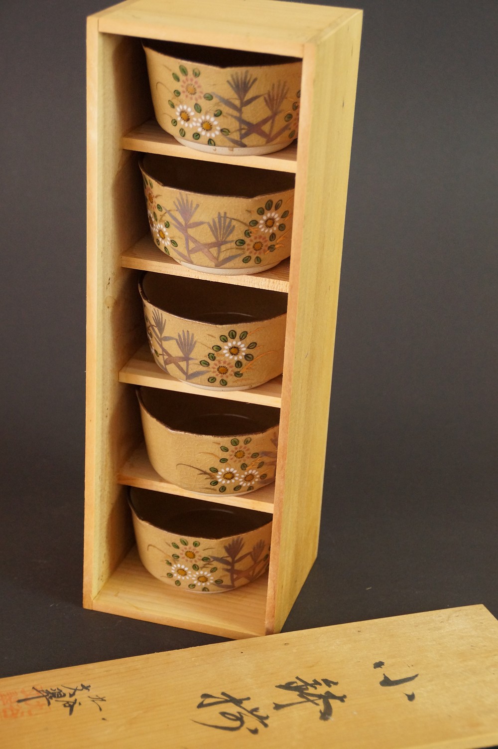 Five bowls in the compartments of the opened storage box