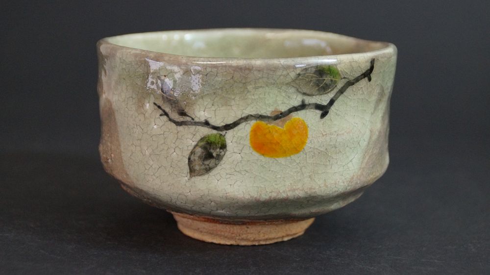 Additional view of the chawan made of Kyoto ware with hand-painted persimmon branch and orange fruit