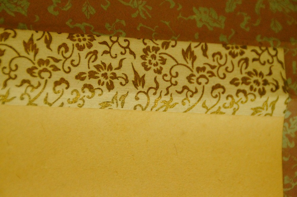 Close-up of the pink brocade border with floral pattern