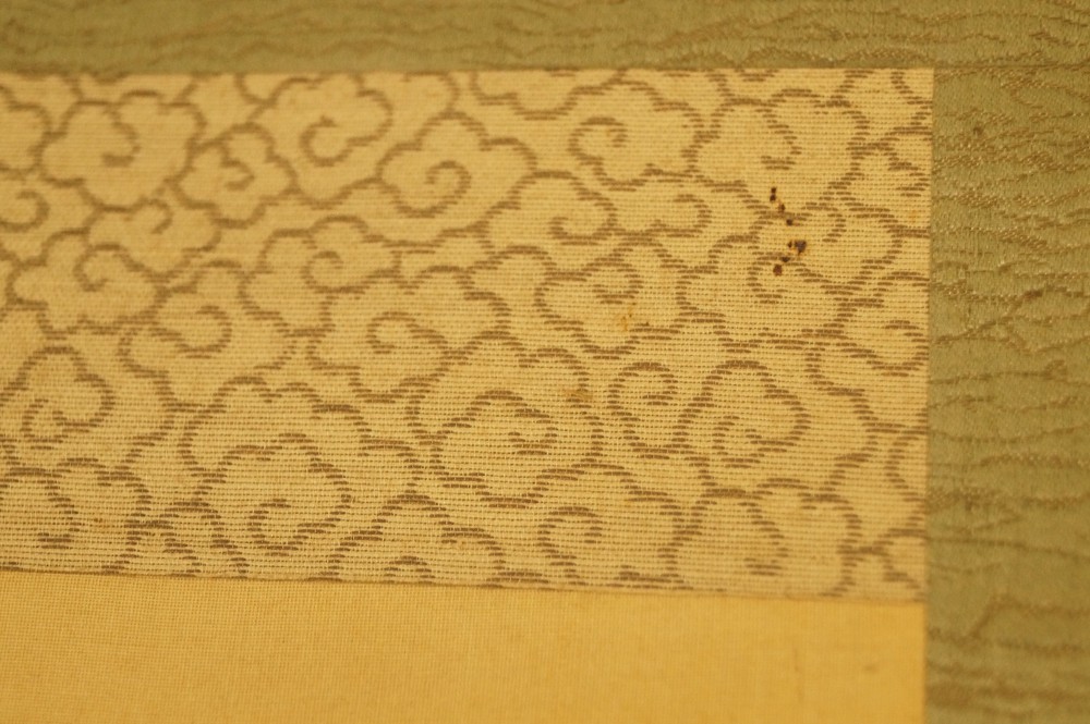 Cream-Colored Cloud Pattern Border on Green Brocade Background Mounting Detail