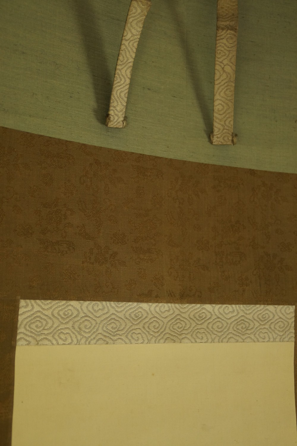 Detail Shot of the Mounting with Turquoise Silk and Brown Brocade