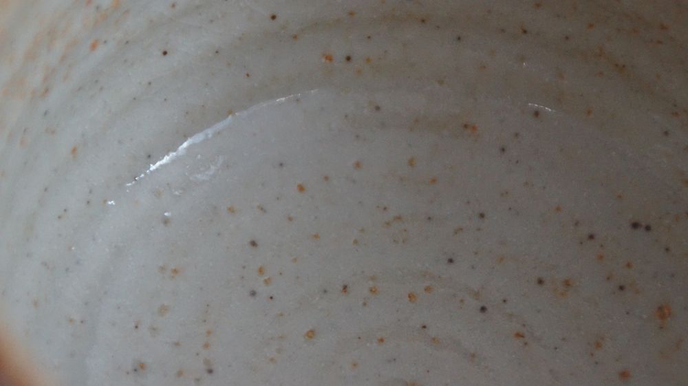 Further close-up of the cream-white interior glaze of the chawan made of Shino ware