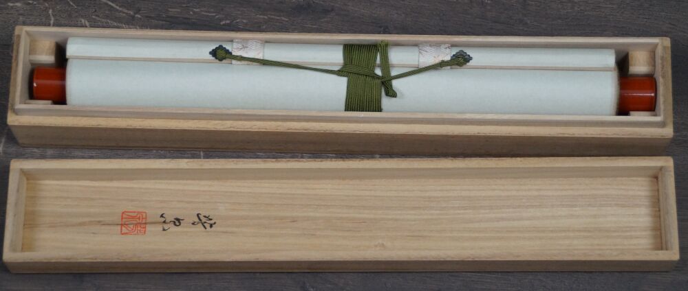 Opened storage box with rolled-up kakemono Pale Pink Plum Blossoms in Spring Light
