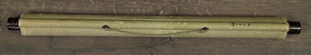 Rolled up hanging scroll tied with a cord with jikusaki made of wood