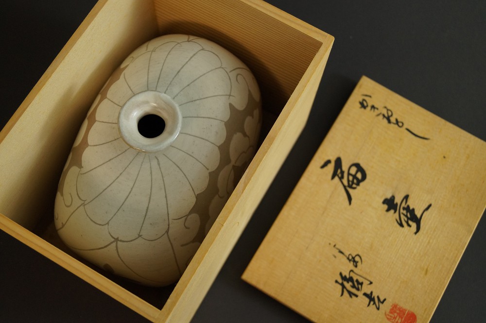 Vase Lying in the Opened Wooden Box Next to Labeled Lid Vase in Storage Box