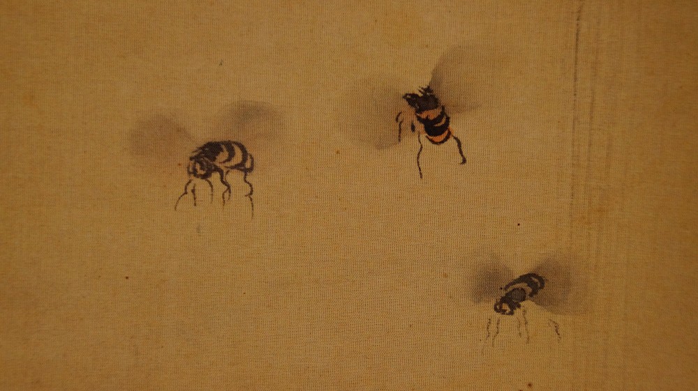 Extreme close-up of the three flying bees on the hanging scroll by Jodo