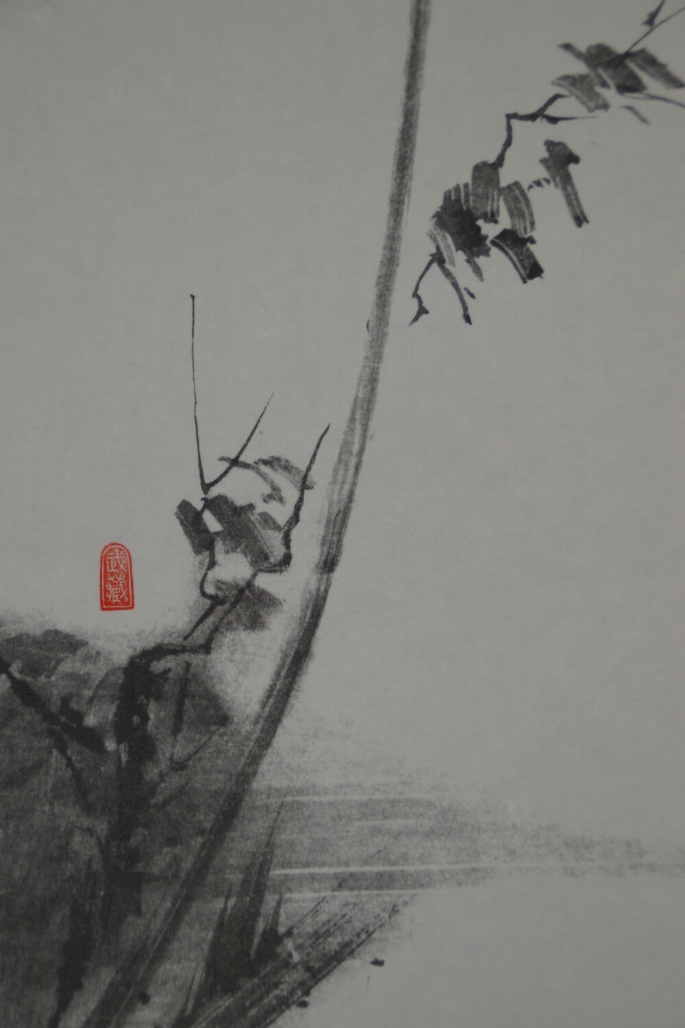 Close-up of the red artist's seal reading Musashi next to blades of grass in the shrike scroll of the triptych after Miyamoto Musashi