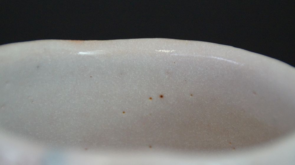 Close-up of the rim of the chawan made of Shino ware with cream-colored glaze