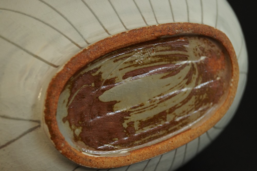 Oval base of the vase with unglazed clay body and potter's mark Close-Up of Base