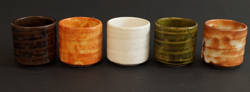 Five Seto sake cups in different glaze colors side by side Set Frontal View